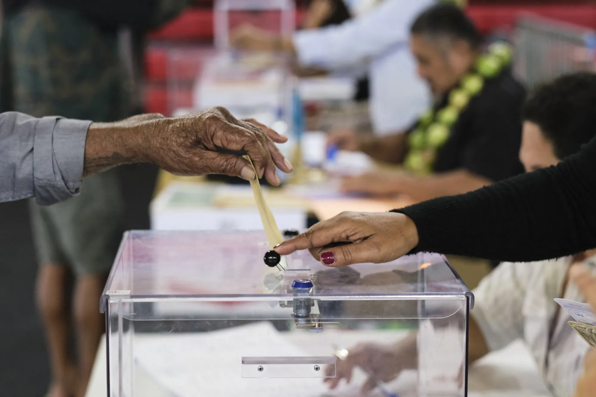 A voter drops their ballot into a ballot box at a&nbsp;polling station&nbsp;in Mont-Dore, New Caledonia&nbsp;on July 7.