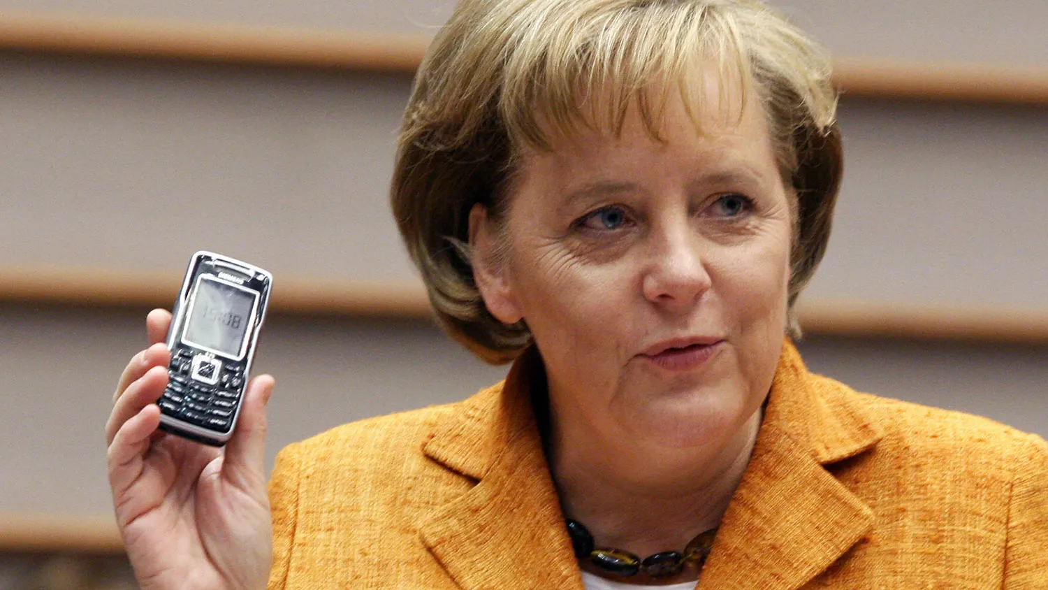 German Chancellor Angela Merkel holds her mobile phone during the plenary session of the European Parliament in Brussels, 27 June 2007.
