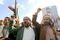 Men hold up an image of Abdul Malik Al-Houthi during a protest in Sanaa, Yemen, on Jan. 5.