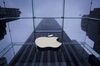 The Apple Inc. logo is seen at the entrance to a store as it rains in New York.