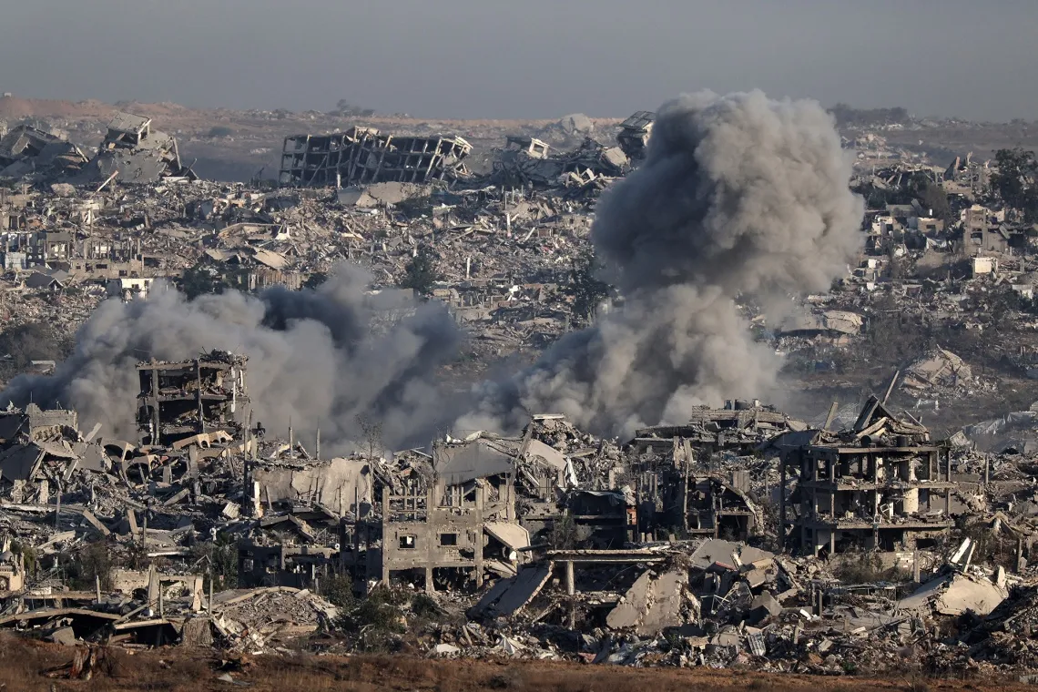Smoke billows&nbsp;over destroyed buildings during an Israeli strike in Gaza on July 17.