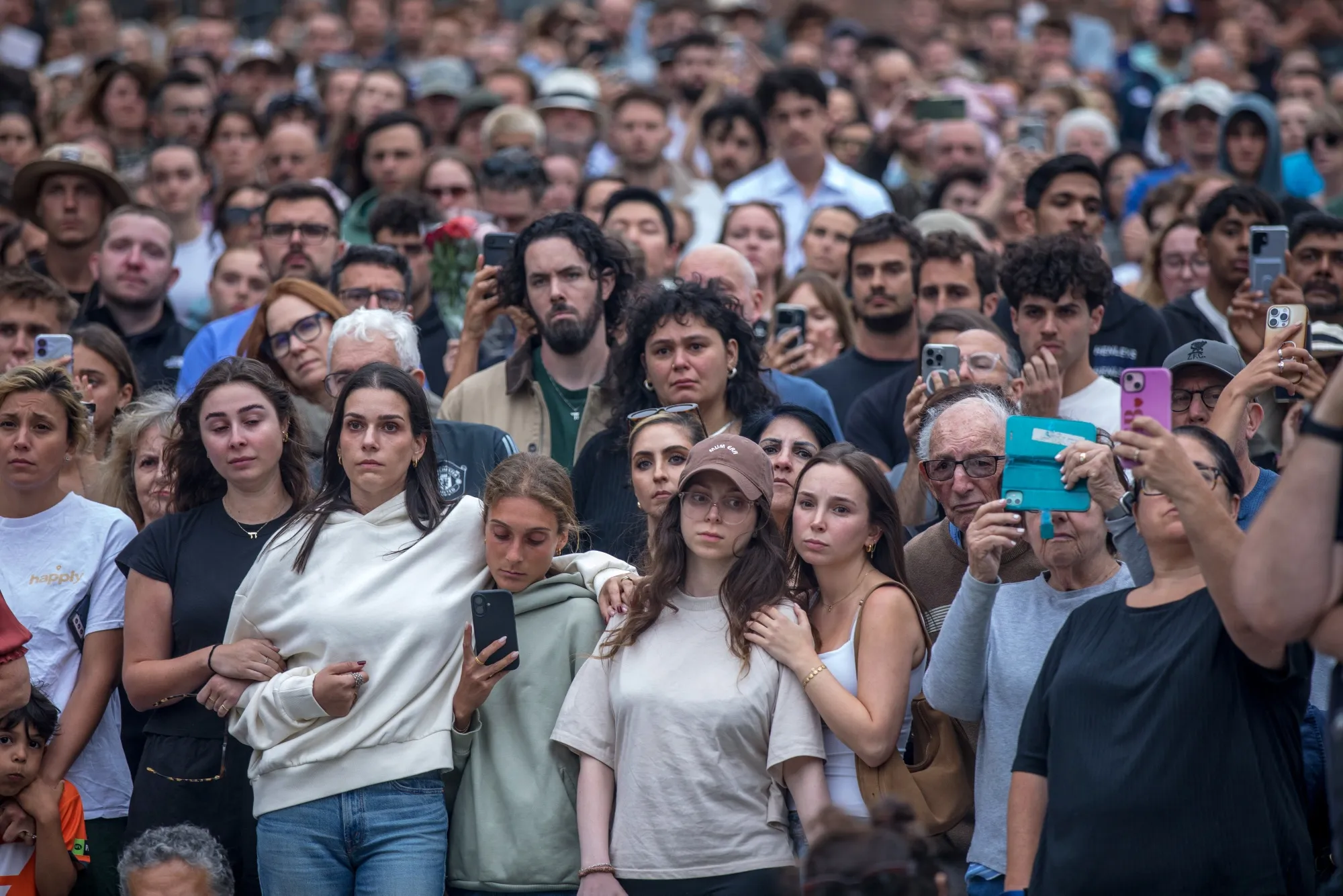 Mourners gather near the site of the mass shooting at Bondi Beach.