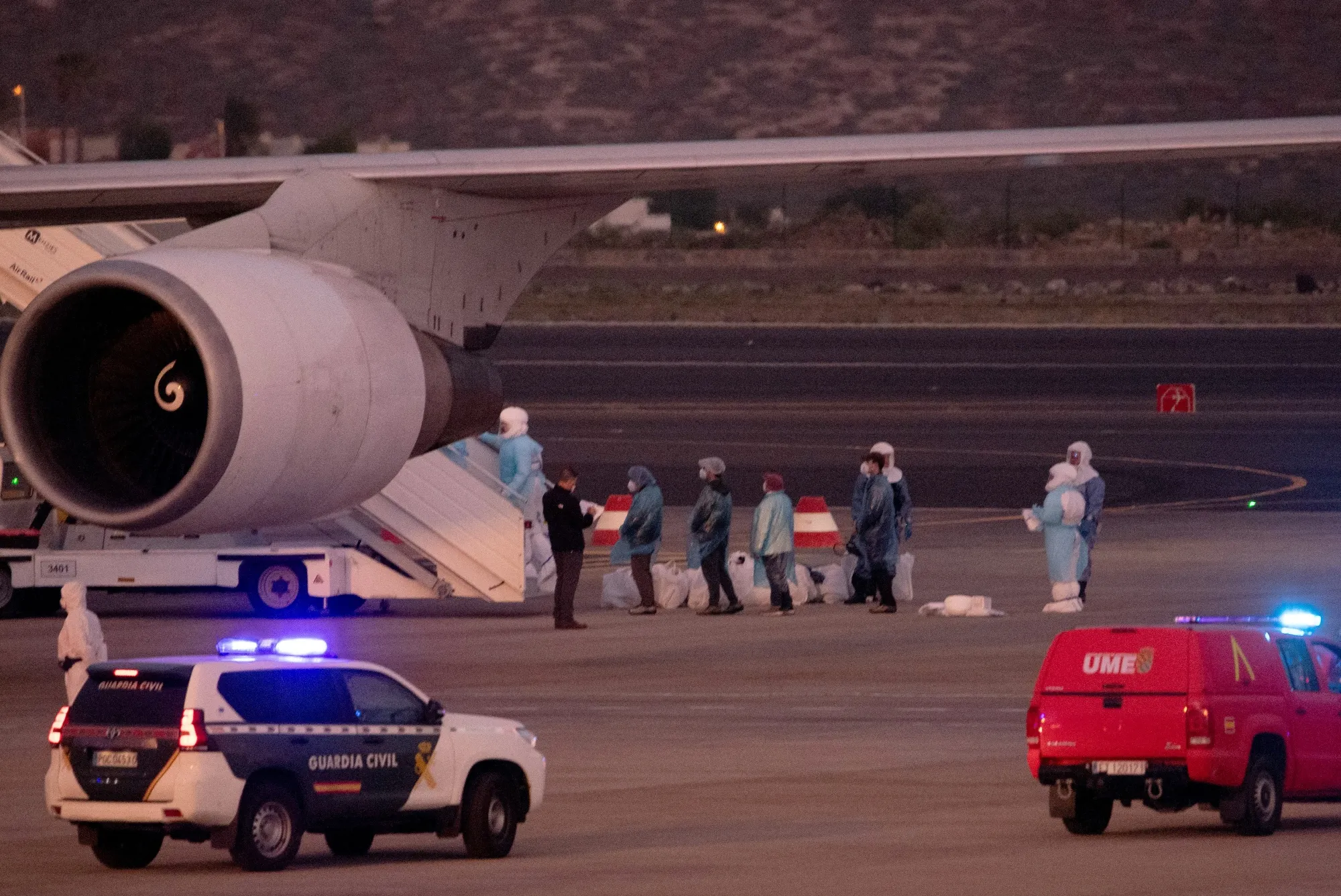 Passengers evacuated from the MV Hondius cruise ship prepare to board a plane at the Tenerife Sur-Reina Sofia airport on the island of Tenerife in Spain's Canary Islands on May 10.