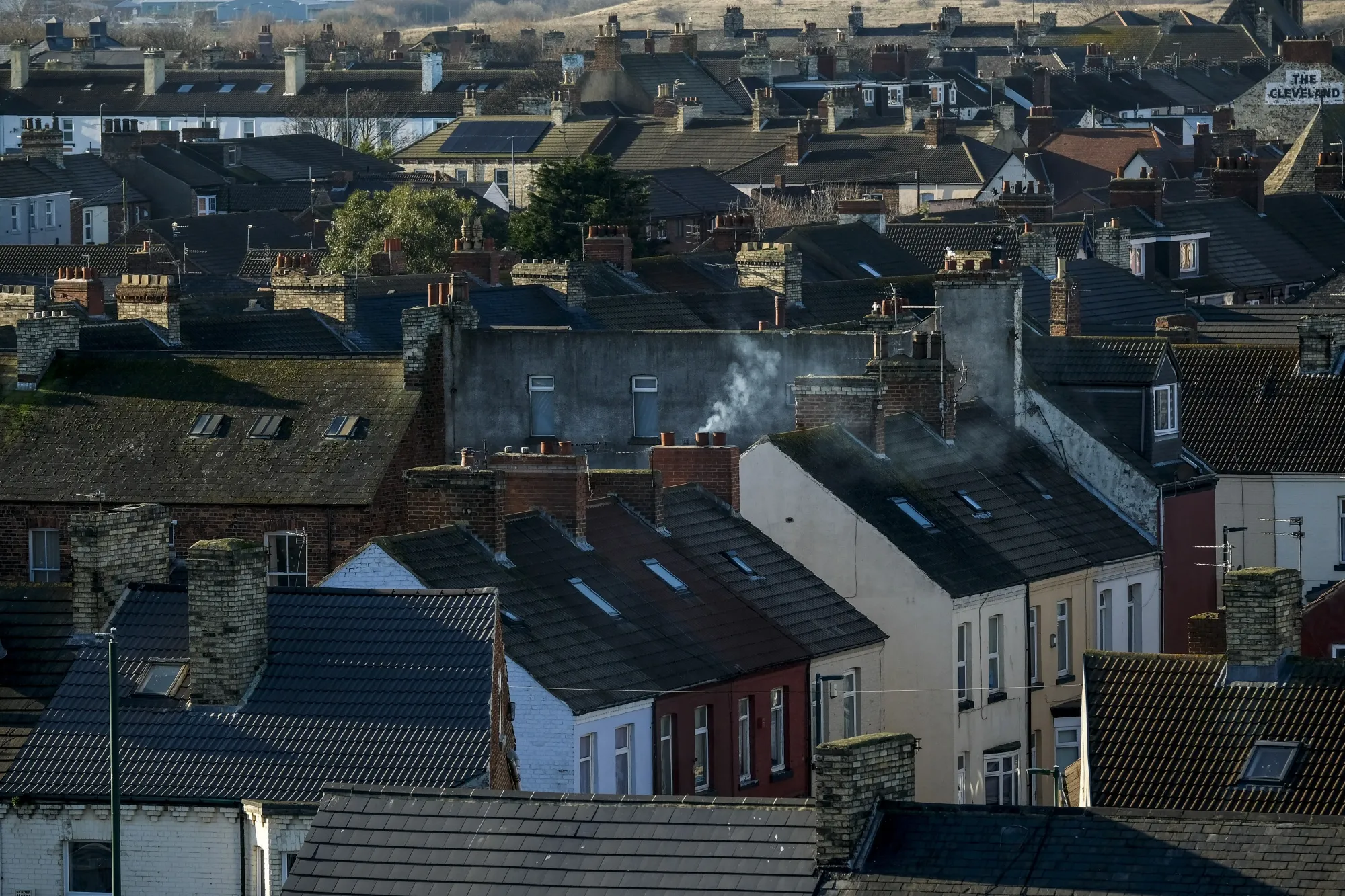 Smoke rises from a chimney of residential houses in Redcar, U.K.