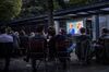 People watch German Chancellor and Christian Democrat (CDU) Angela Merkel debate with her main opponent, Social Democrat (SPD) and chancellor candidate Martin Schulz.