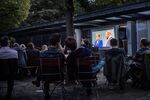 People watch German Chancellor and Christian Democrat (CDU) Angela Merkel debate with her main opponent, Social Democrat (SPD) and chancellor candidate Martin Schulz.
