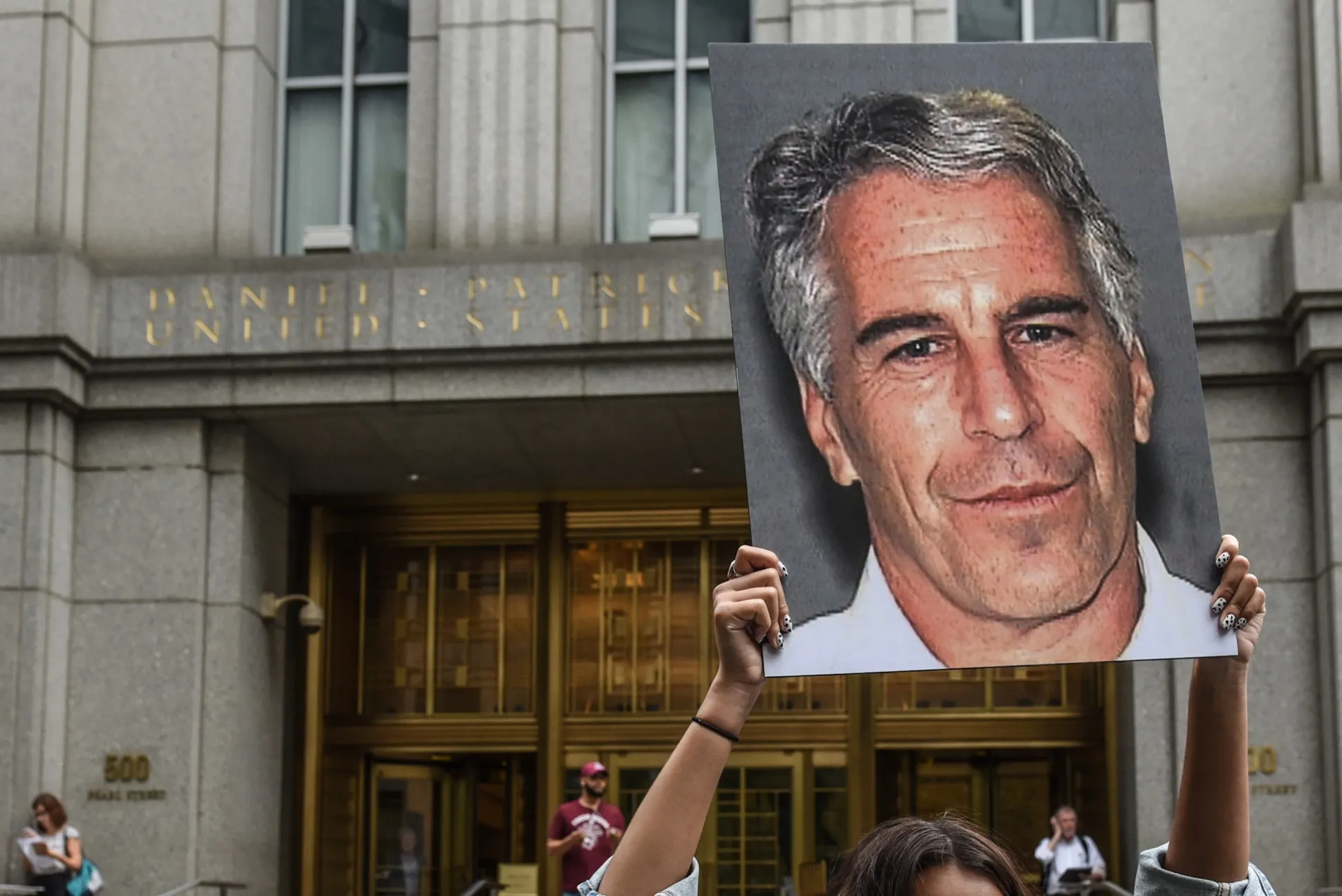 A demonstrator holds&nbsp;up a&nbsp;sign&nbsp;of Jeffrey Epstein in front of the federal courthouse&nbsp;in New York&nbsp;in 2019.