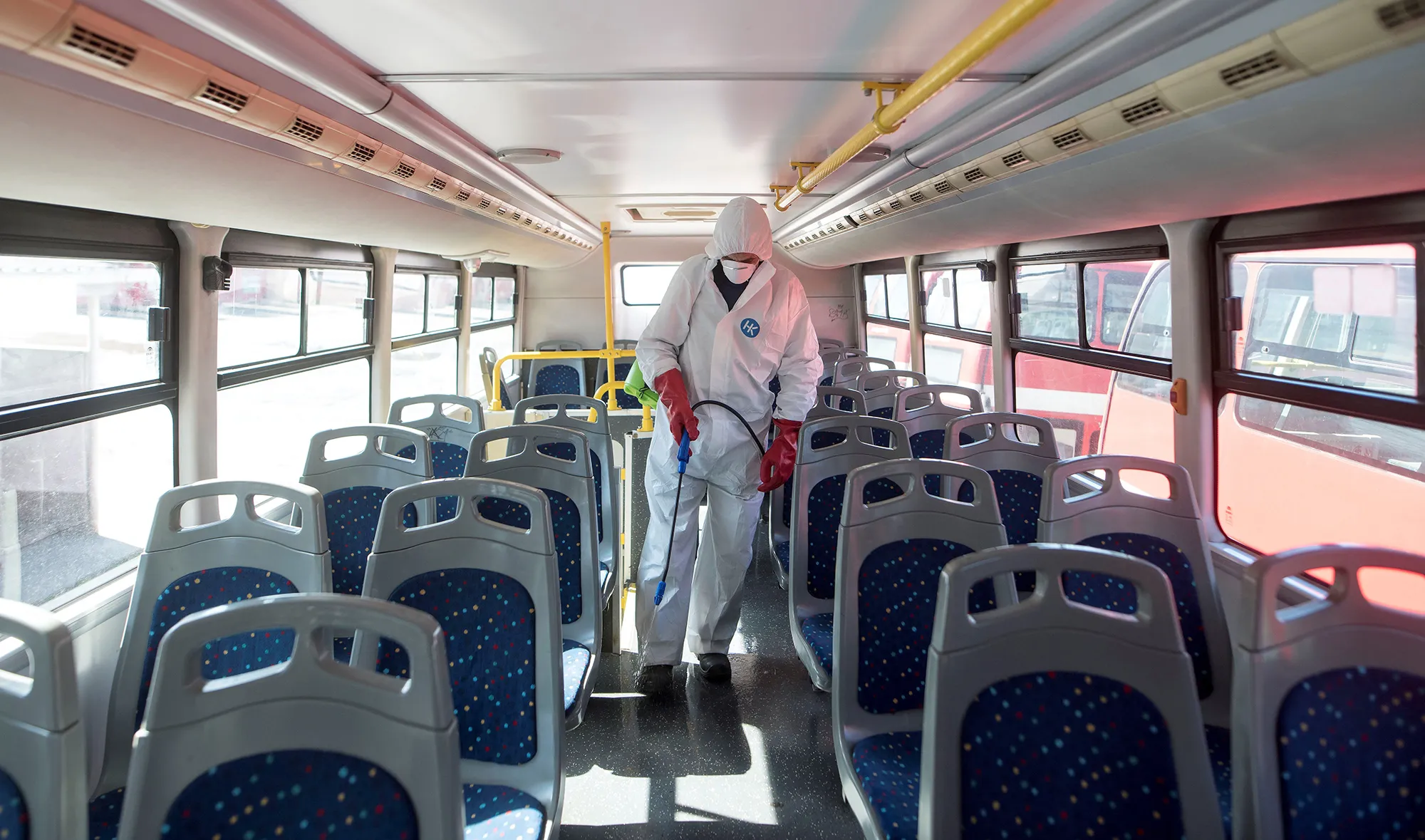 A worker disinfects a public bus against COVID-19, the novel coronavirus, in Skopje on Feb. 29, 2020.
