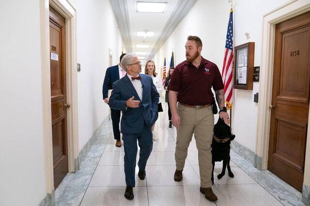 Representative Patrick McHenry, a Republican from North Carolina, walks with a veteran and his service dog, beneficiaries of America's VetDogs program, on Capitol Hill in Washington, D.C., US, on Wednesday, December 14, 2022. 