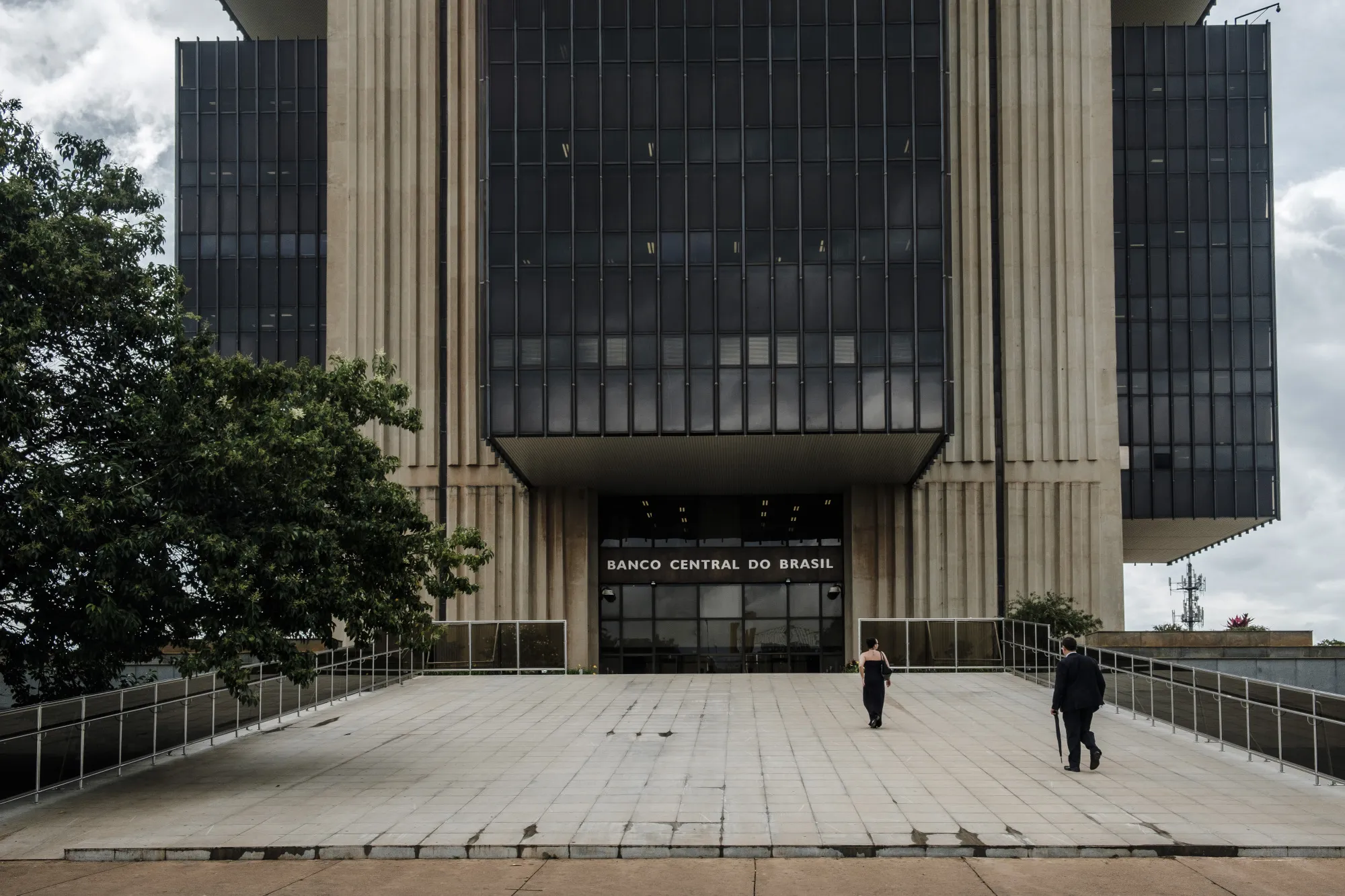 Pedestrians pass in front of the Central Bank of Brazil headquarters in Brasilia.