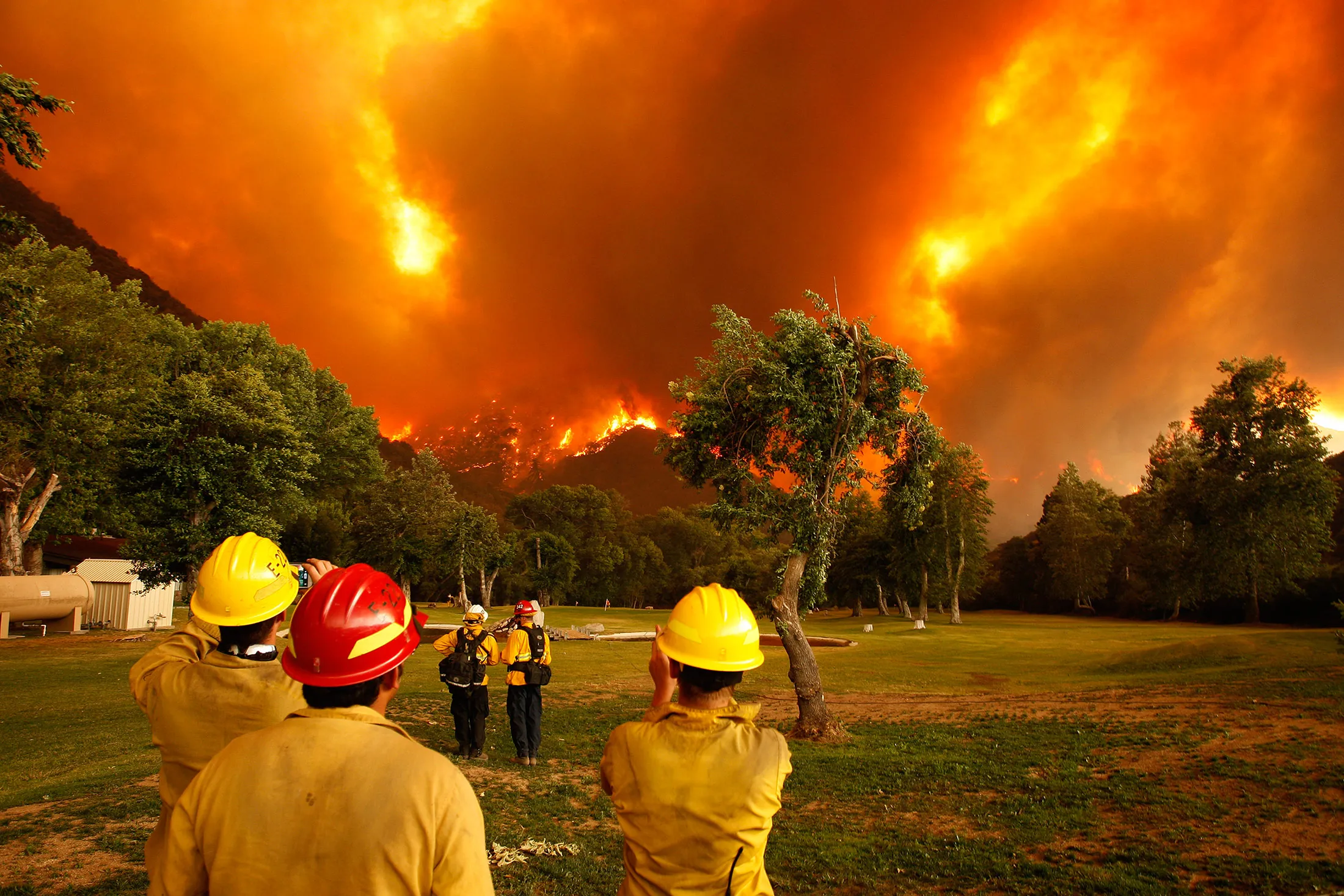 Firefighters watch as the Powerhouse fire closes in around them during a fast run toward Lake Hughes, Calif., on June 1, 2013. The 19,500-acre wildfire destroyed numerous homes overnight.
