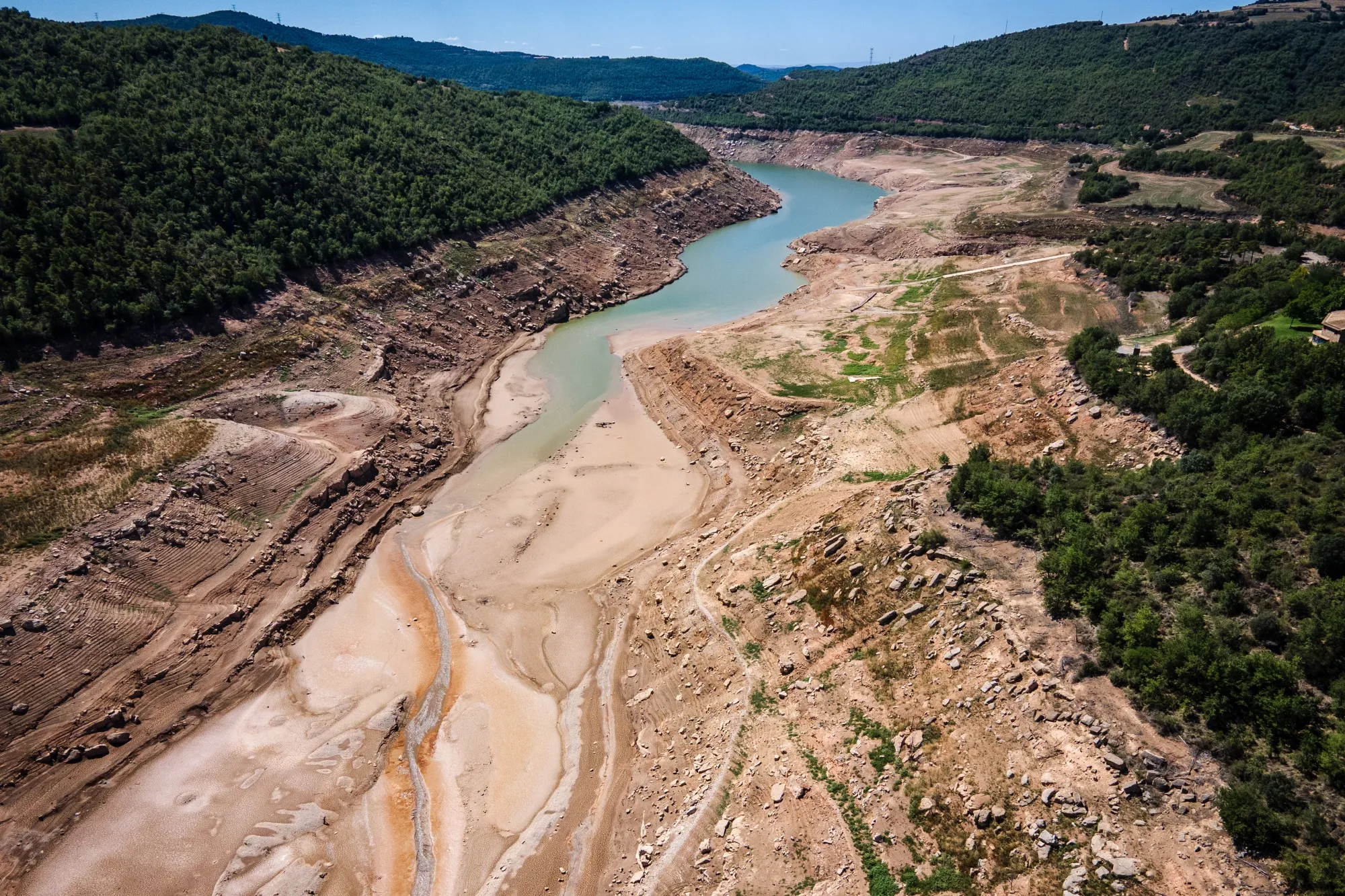 Extremely low water levels on the exposed bed of the Rialb reservoir during a drought in La Baronia De Rialb, Spain in 2022.