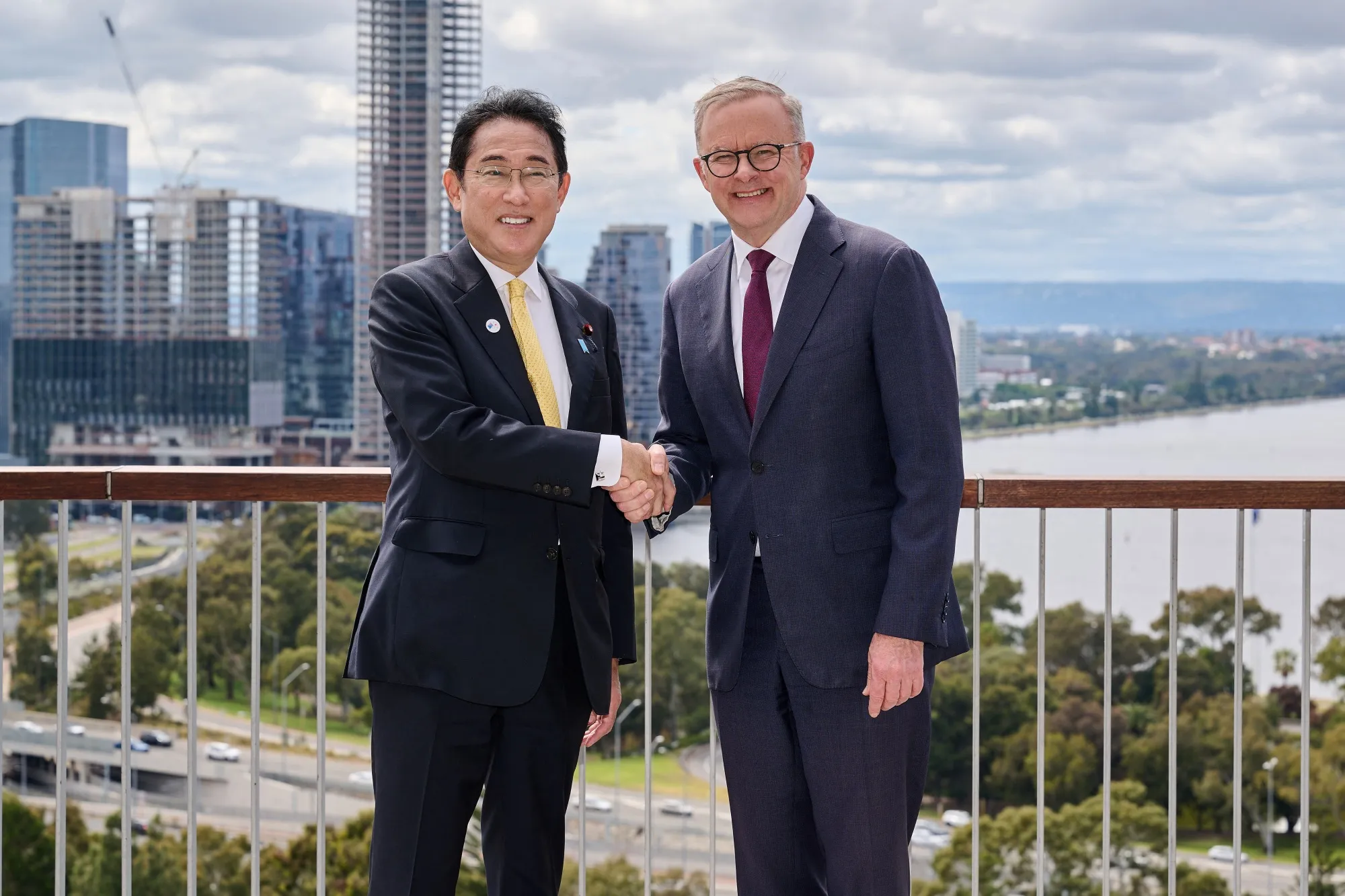 Fumio Kishida, left, shakes hands with Anthony Albanese in Perth on Oct. 22.