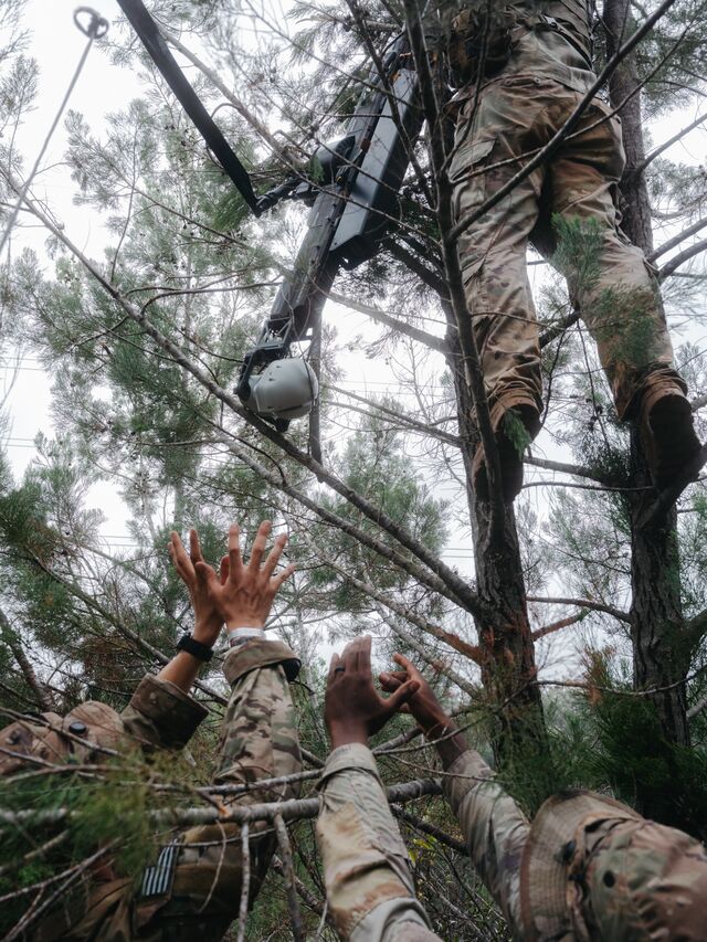 Soldiers retrieve a crashed Ghost-X drone during a training exercise at the Jungle Operations Training Center.