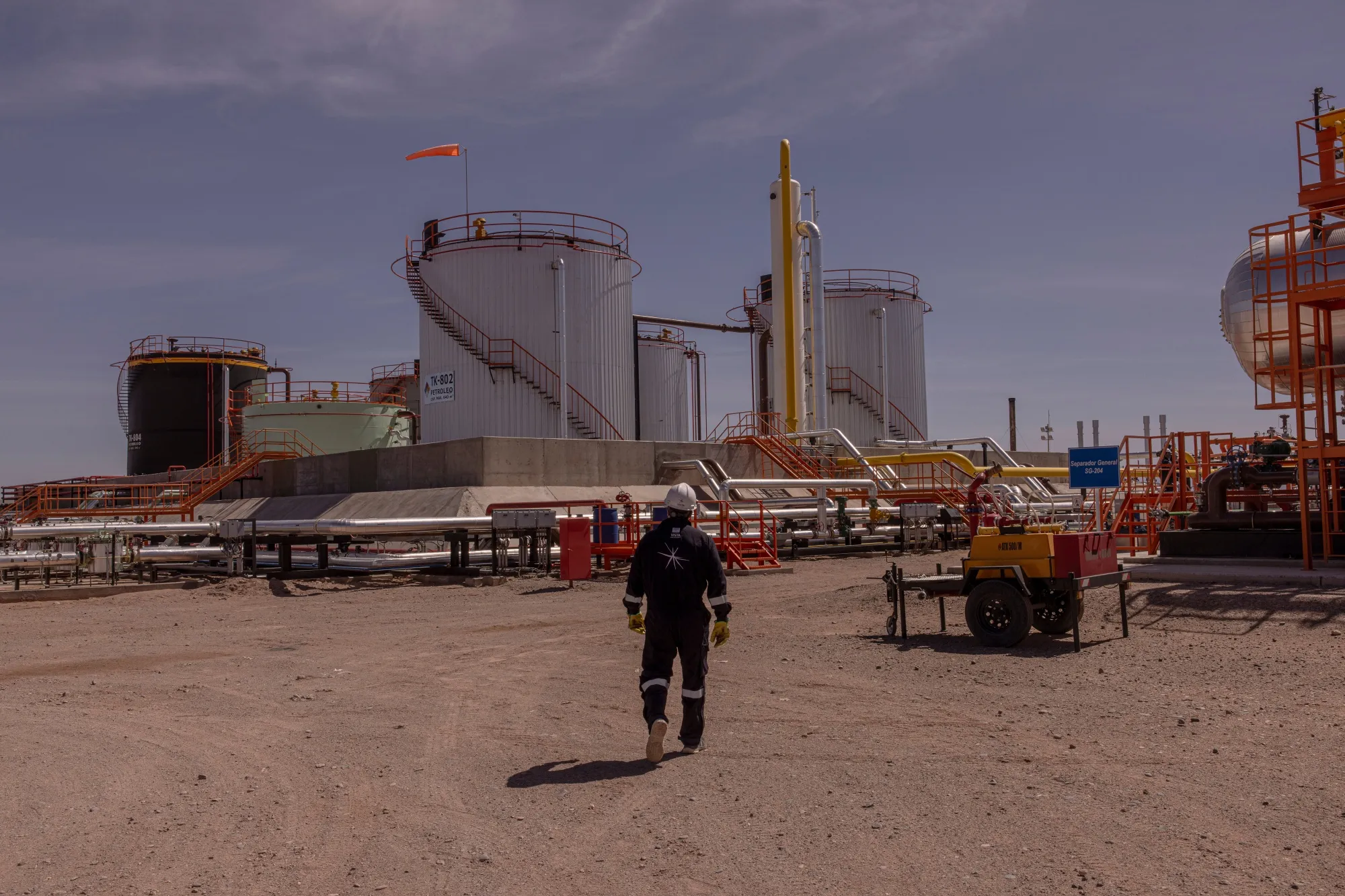 A worker walks through the treatment plant at a Vista Energy oil and gas field in Neuquen, Argentina.