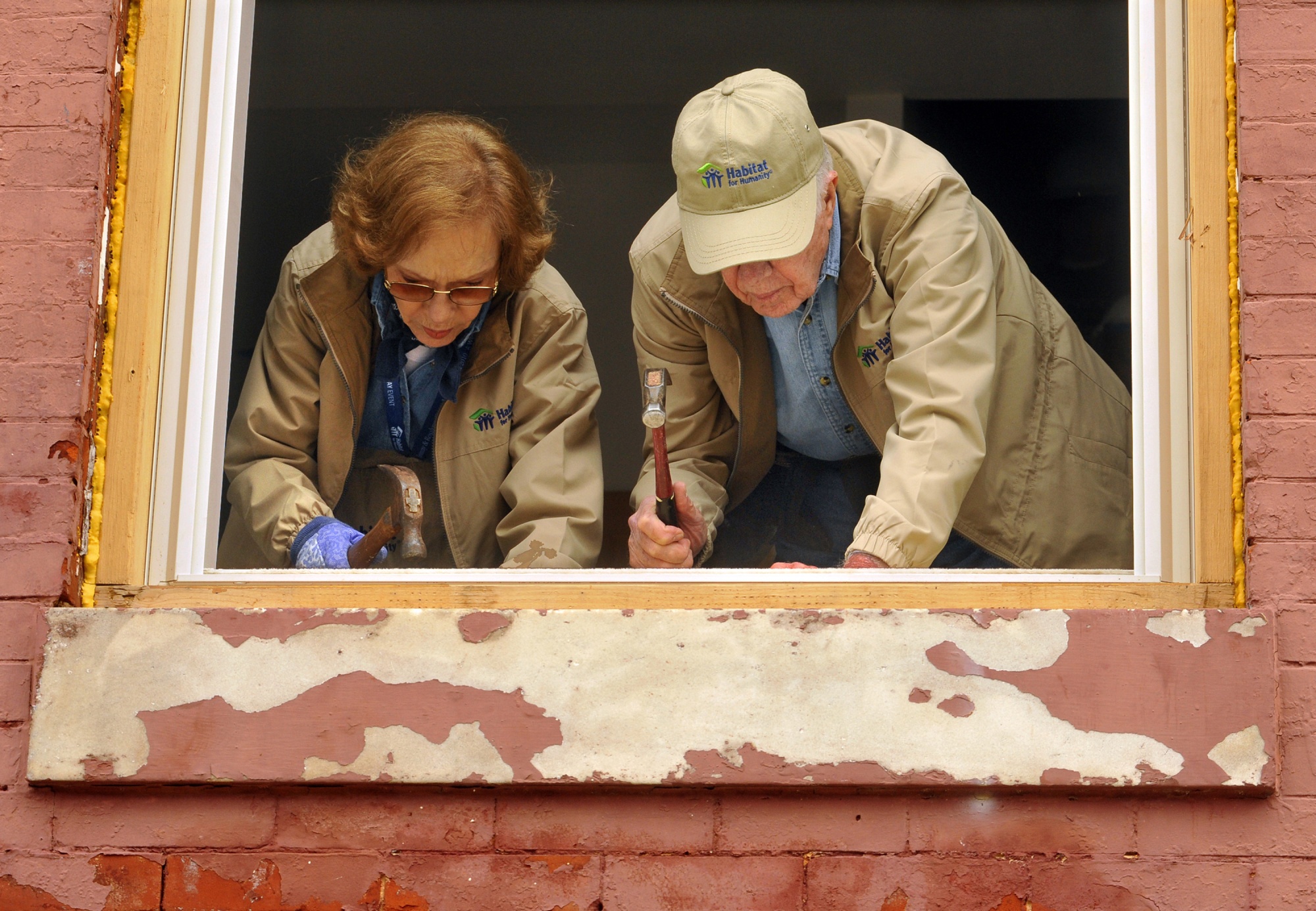 Former President Jimmy Carter and Rosalynn Carter at work renovating a rowhouse in Baltimore in&nbsp;2010.&nbsp;