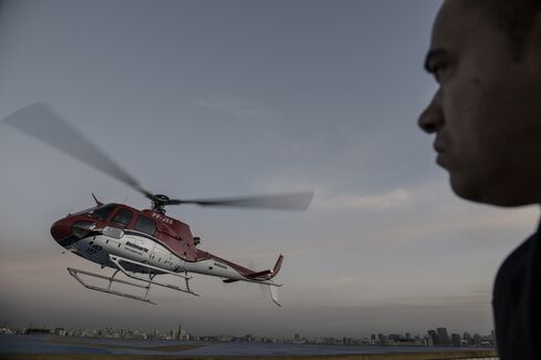 A security officer looks on as an UberCopter lands at the Blue Tree Hotel Heliport in São Paulo on June 17, 2016.
