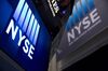 The New York Stock Exchange (NYSE) logo is displayed above the trading floor in New York, U.S., on Tuesday, June 24, 2014. U.S. stocks rose, with equity benchmarks trading near all-time highs, as data showing a gain in consumer confidence and a surge in sales of new homes boosted optimism about growth in the world’s largest economy.