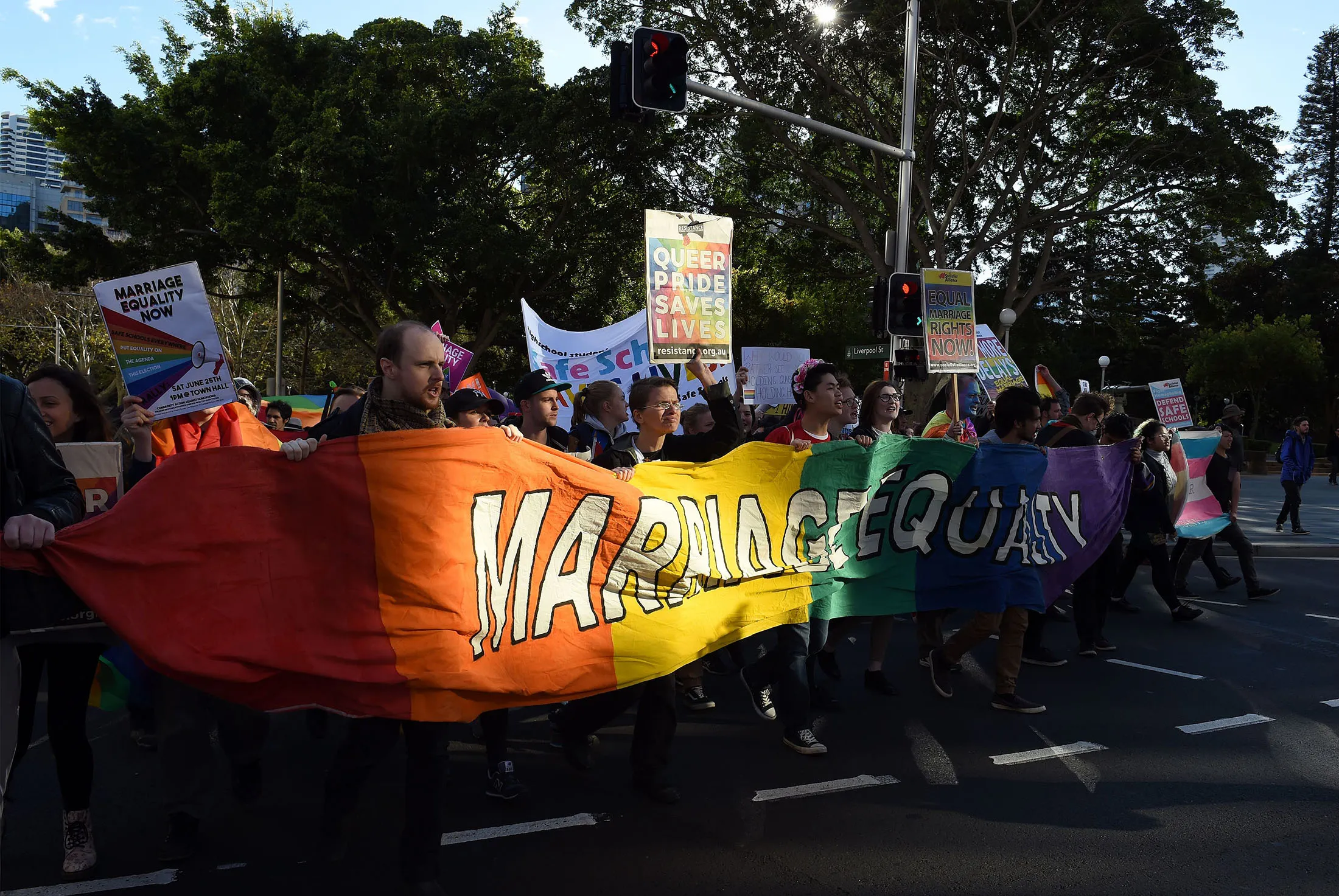 Pro-gay marriage supporters carry a rainbow banner and flags during a rally in Sydney on June 25. Australia's Labor party rejected Prime Minister Malcolm Turnbull’s plan to hold a public vote on same-sex marriage.
