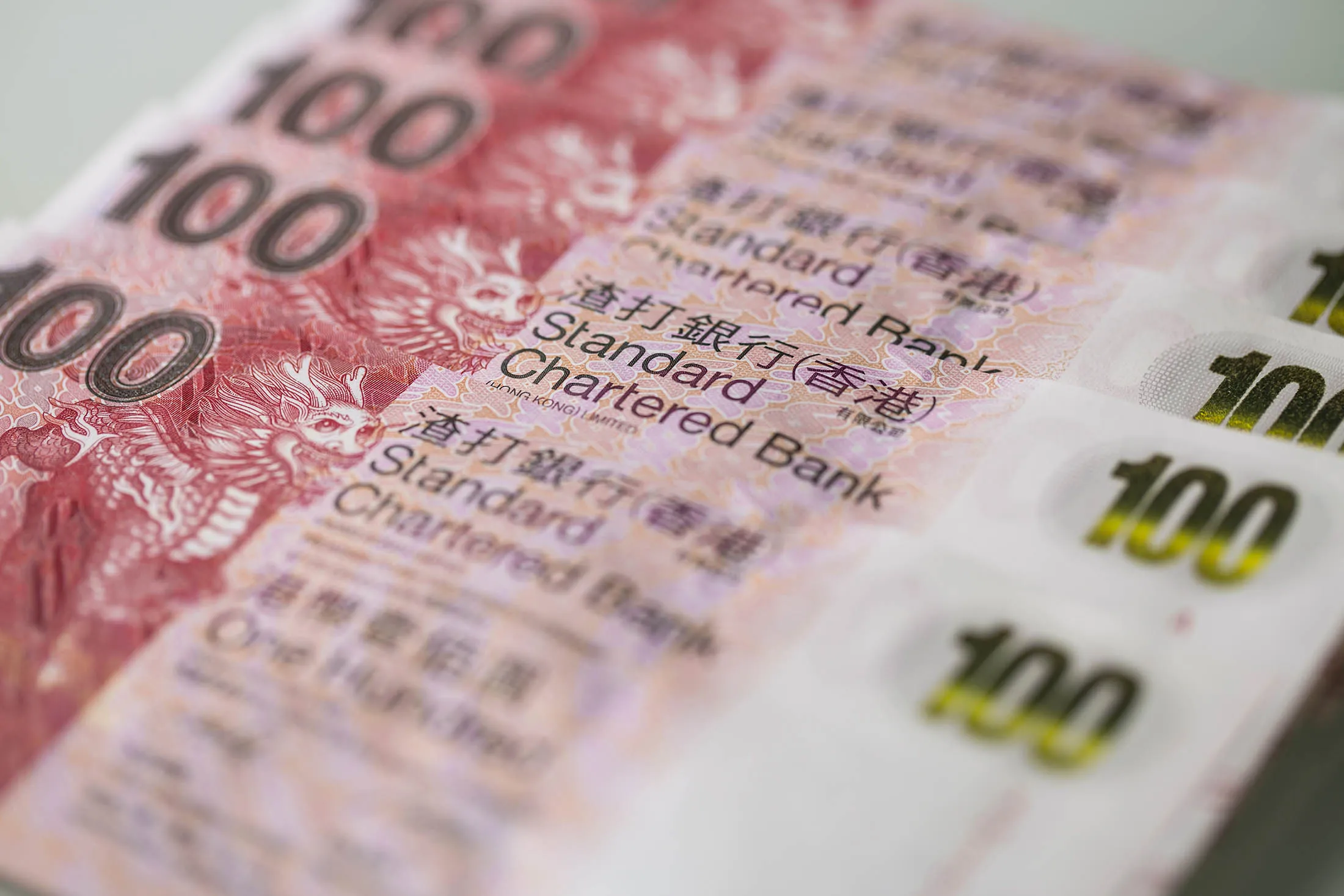 Hong Kong one-hundred dollar banknotes are arranged for a photograph in Hong Kong, China, on Wednesday, Jan. 20, 2016. Hong Kong dollar forwards sank to their weakest level this century, interbank loan rates jumped the most in seven years and the Hang Seng Index tumbled as China's market turmoil fueled speculation the city's 32-year-old currency peg will end.

