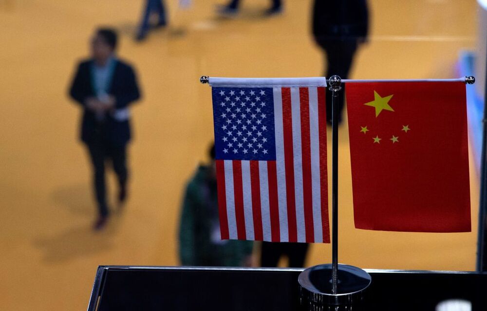 Chinese and US flag at a booth during the first China International Import Expo (CIIE) in Shanghai.