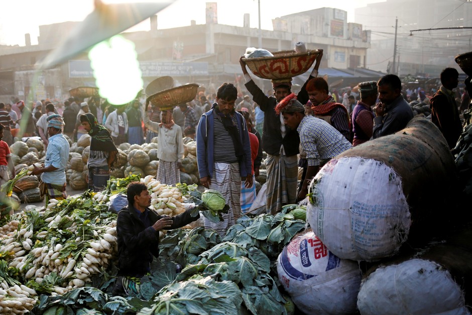 A vendor sells vegetables at Kawran Bazar in Dhaka, Bangladesh.