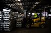 A worker uses a forklift to move aluminum ingots in a warehouse at the Port of New Orleans in Louisiana, U.S.