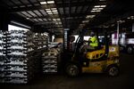 A worker uses a forklift to move aluminum ingots in a warehouse at the Port of New Orleans in Louisiana, U.S.