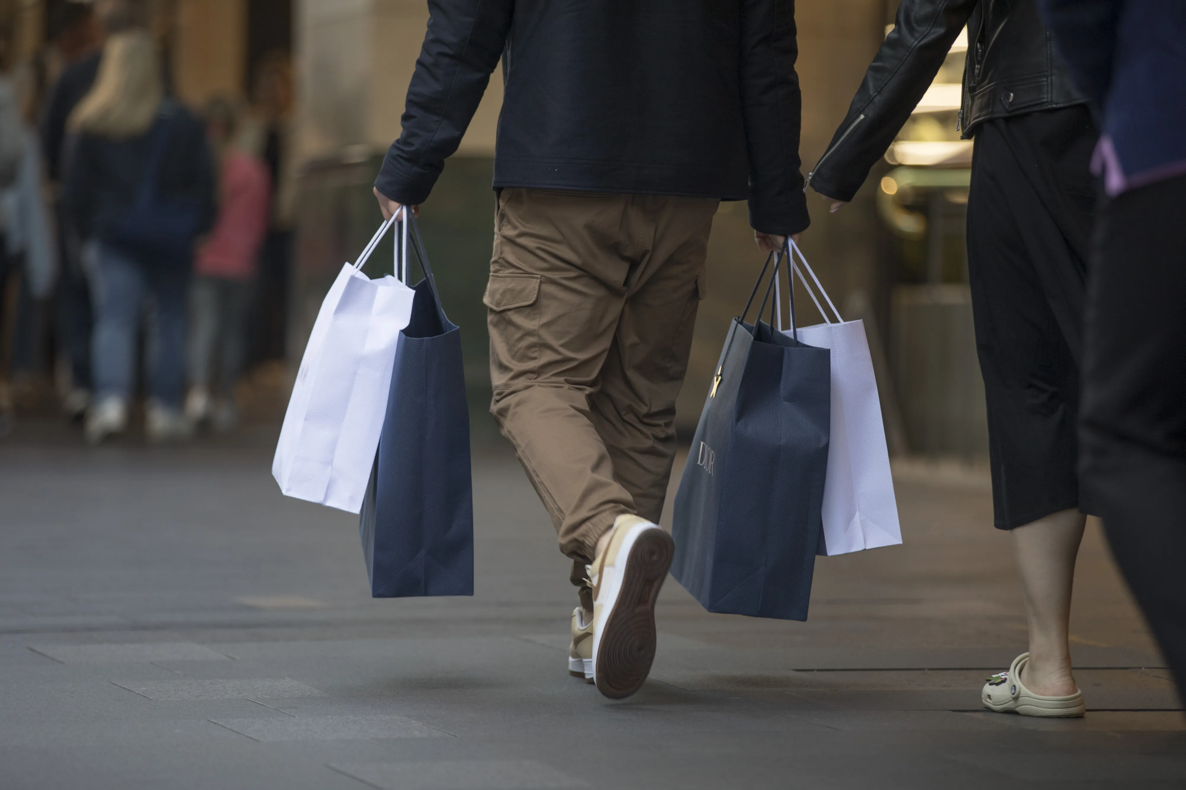 A man carries shopping bags at Pitt Street Mall in Sydney.