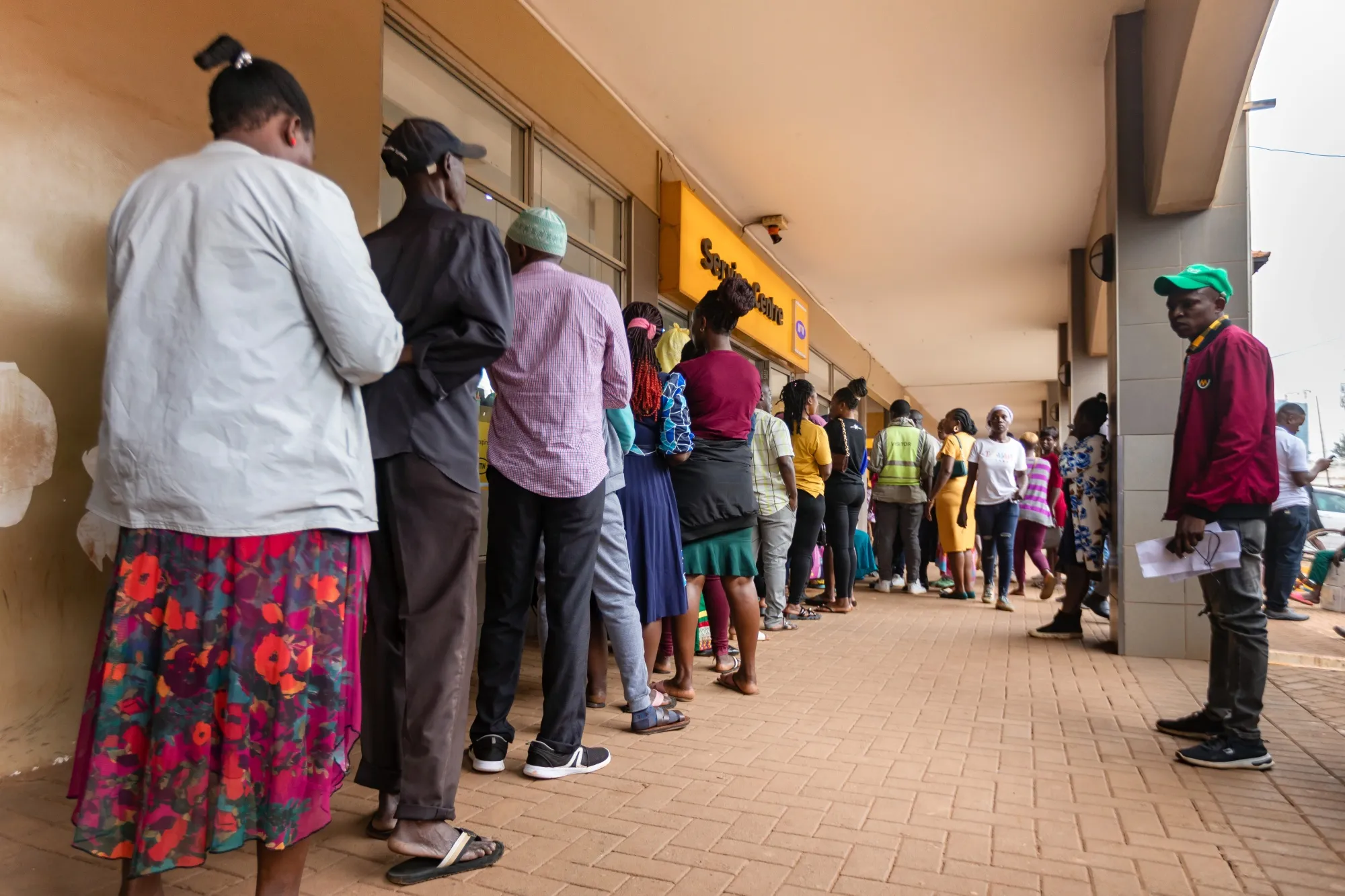 People whose SIM cards were deactivated because they lacked National Identity cards line up at a mobile service center in Kampala, Uganda on Nov. 13.
