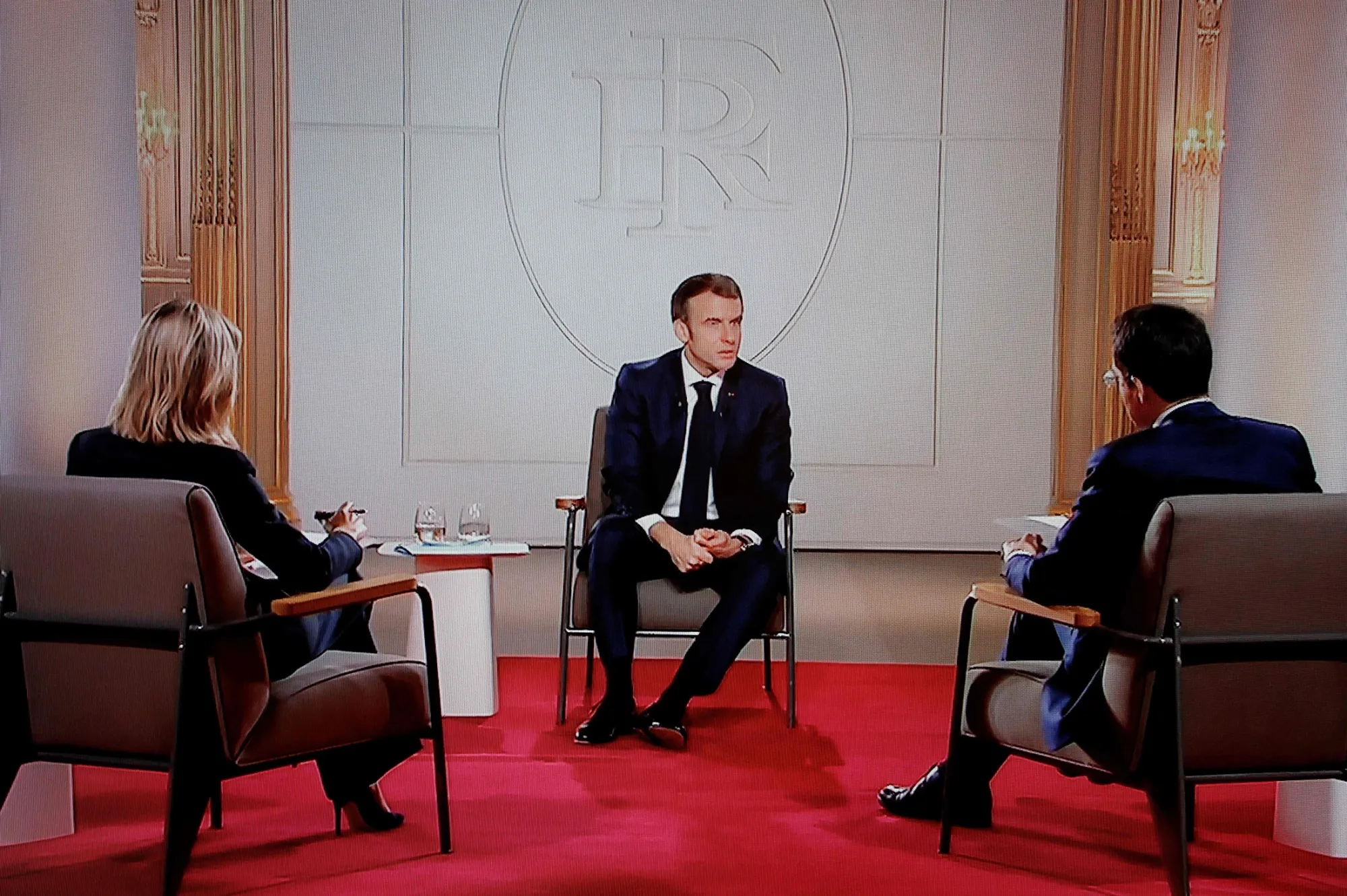  Emmanuel Macron, center, on a television screen broadcasting French TV channel TF1 on Dec. 15.