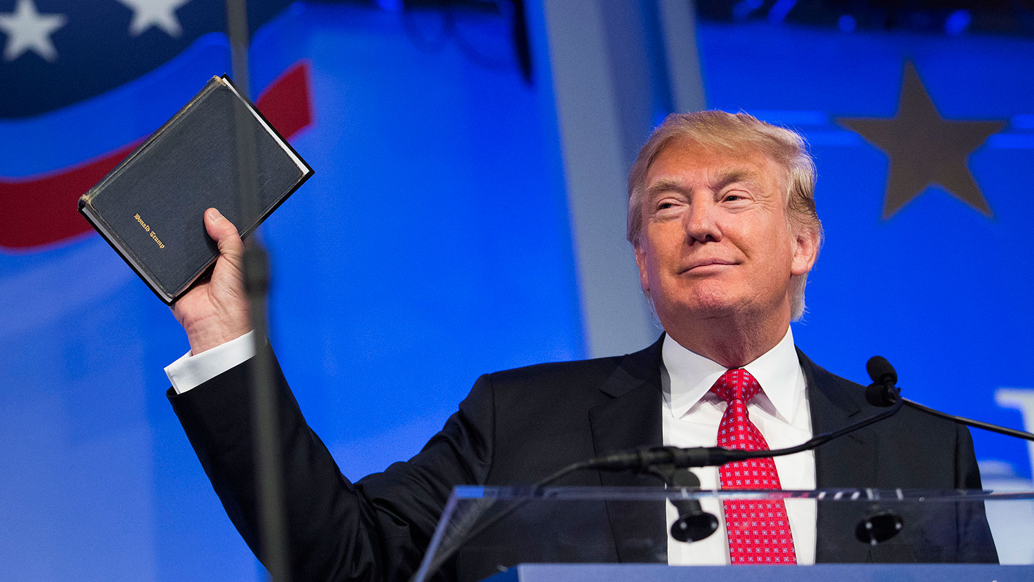 Donald Trump holds up a Bible while speaking at the Values Voter Summit in Washington on Sept. 25, 2015.
