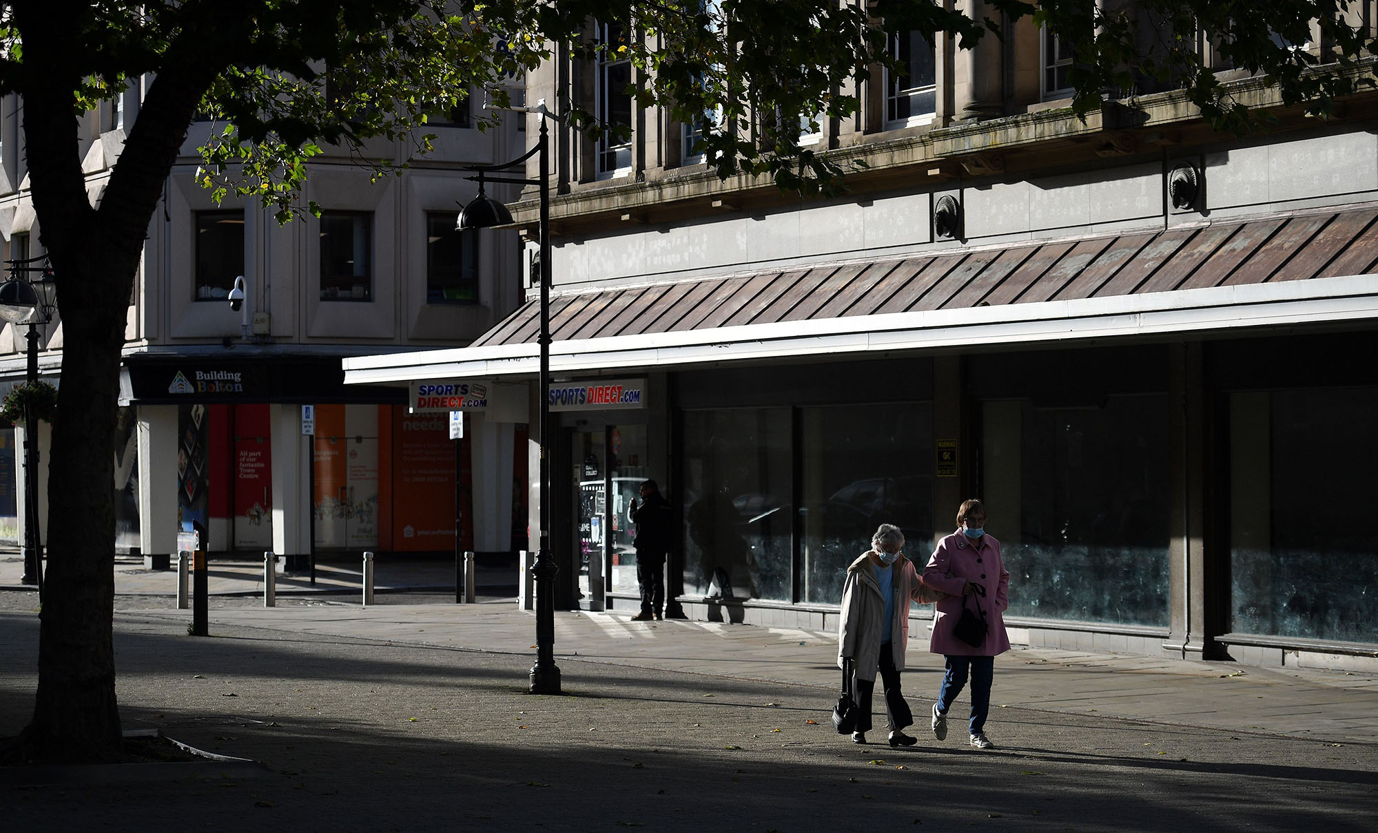 Pedestrians in Bolton town centre, northwest England.