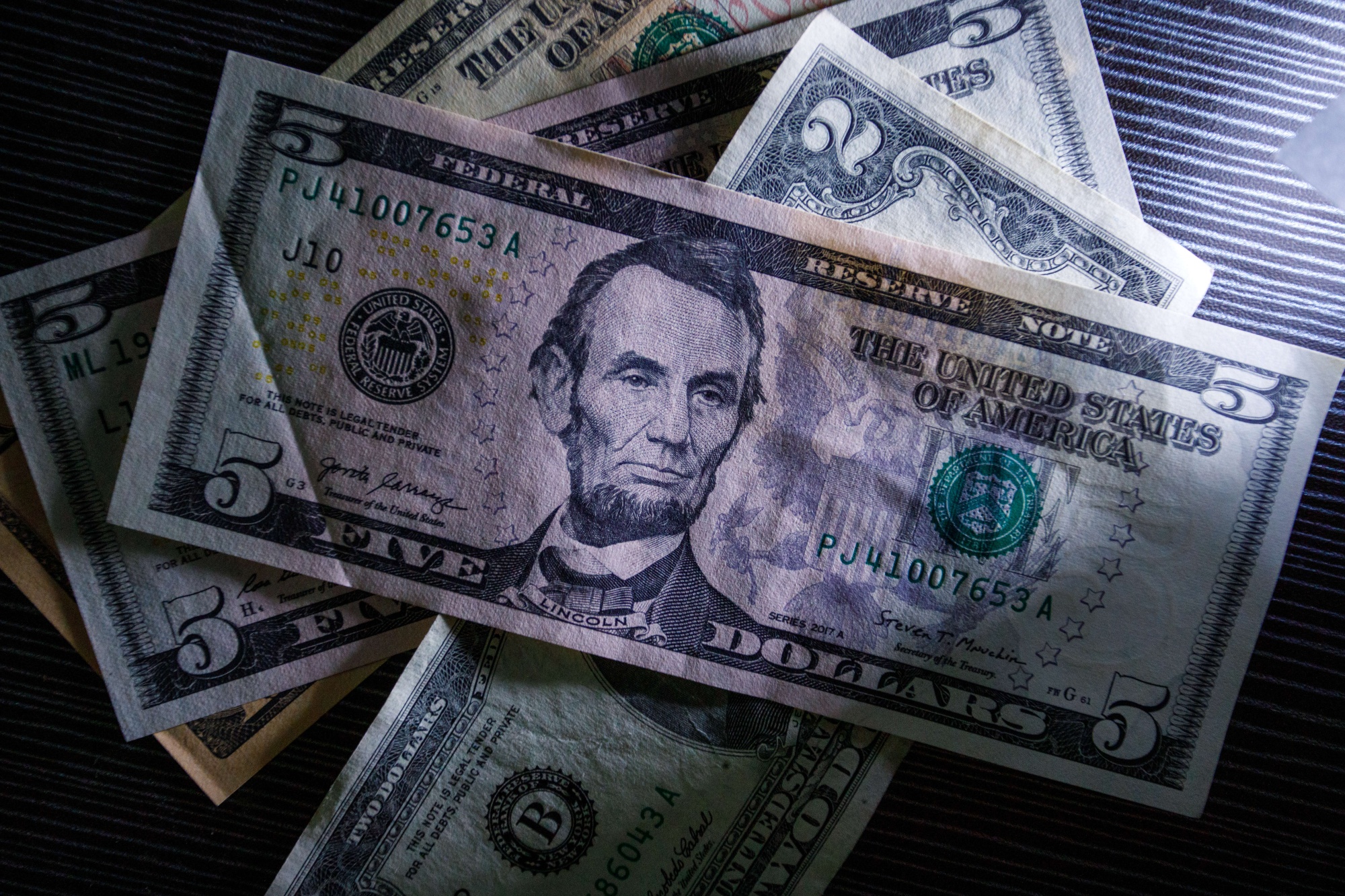 Closeup Of Fifty Dollar Bills On Wooden Table. Fifty Dollar Stock