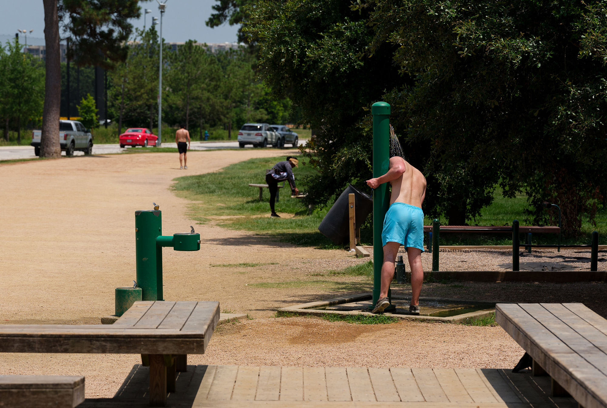 A runner cools off under&nbsp;an outdoor shower at a park in Houston, Texas, on&nbsp;June 15.