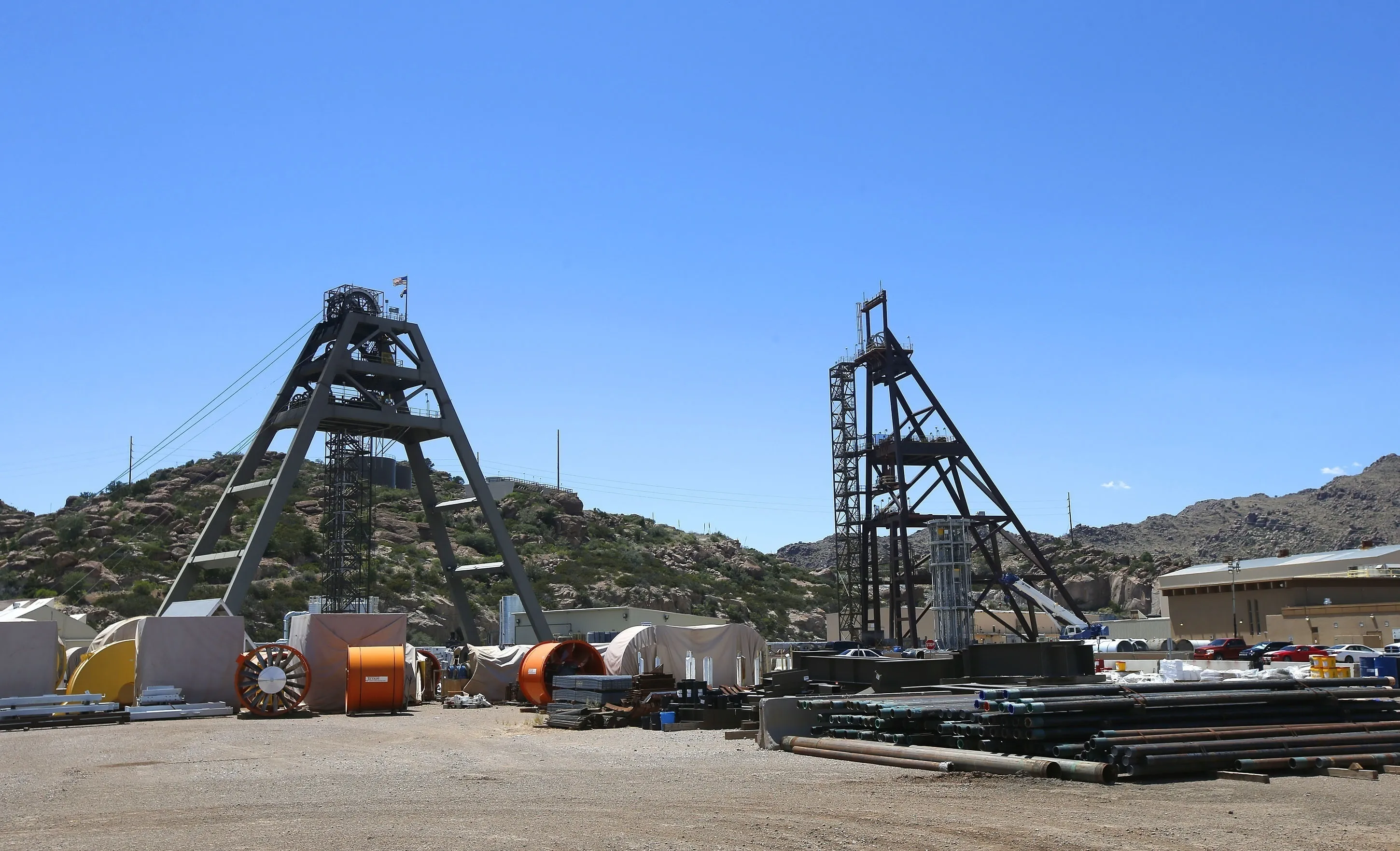 Equipment stands around the Resolution Copper Mining area Shaft #9, right, and Shaft #10, left, that awaits the expansion go ahead in Superior, Ariz.,  June 15, 2015. A federal agency says an environmental review for a proposed copper mine in Arizona falls short on details about water and the potential impacts of climate change. (AP Photo/Ross D. Franklin, File)