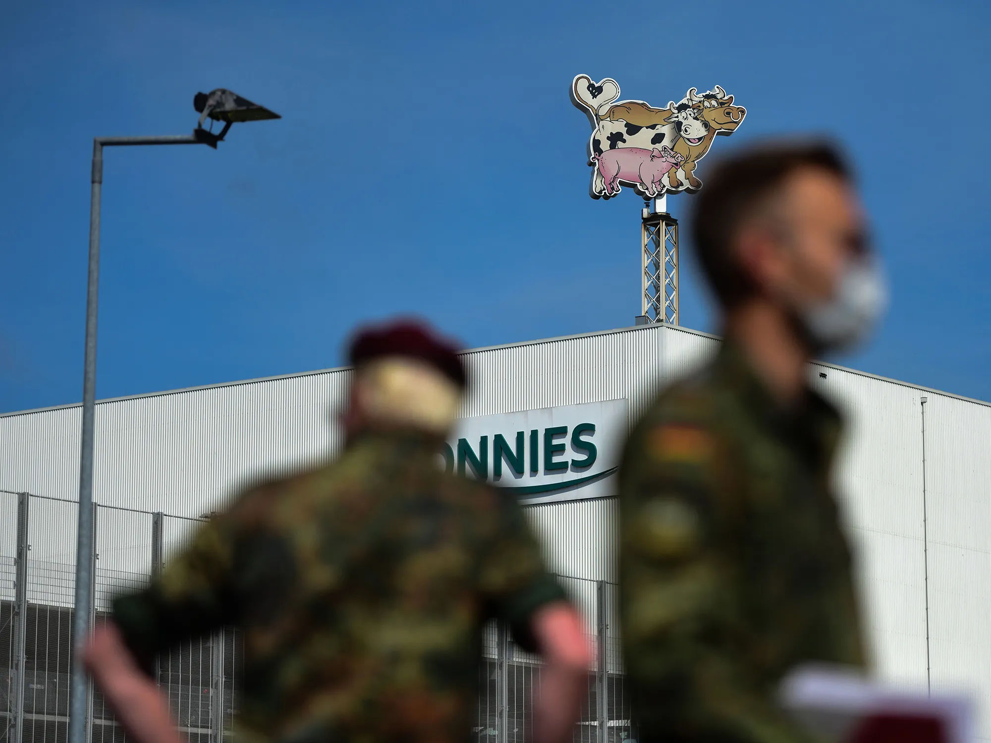German soldiers stand near the Toennies GmbH factory in Rheda-Wiedenbrueck, Germany, on June 19