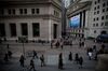 Pedestrians walk along Wall Street near the New York Stock Exchange (NYSE) in New York, U.S., on Monday, March 19, 2018.