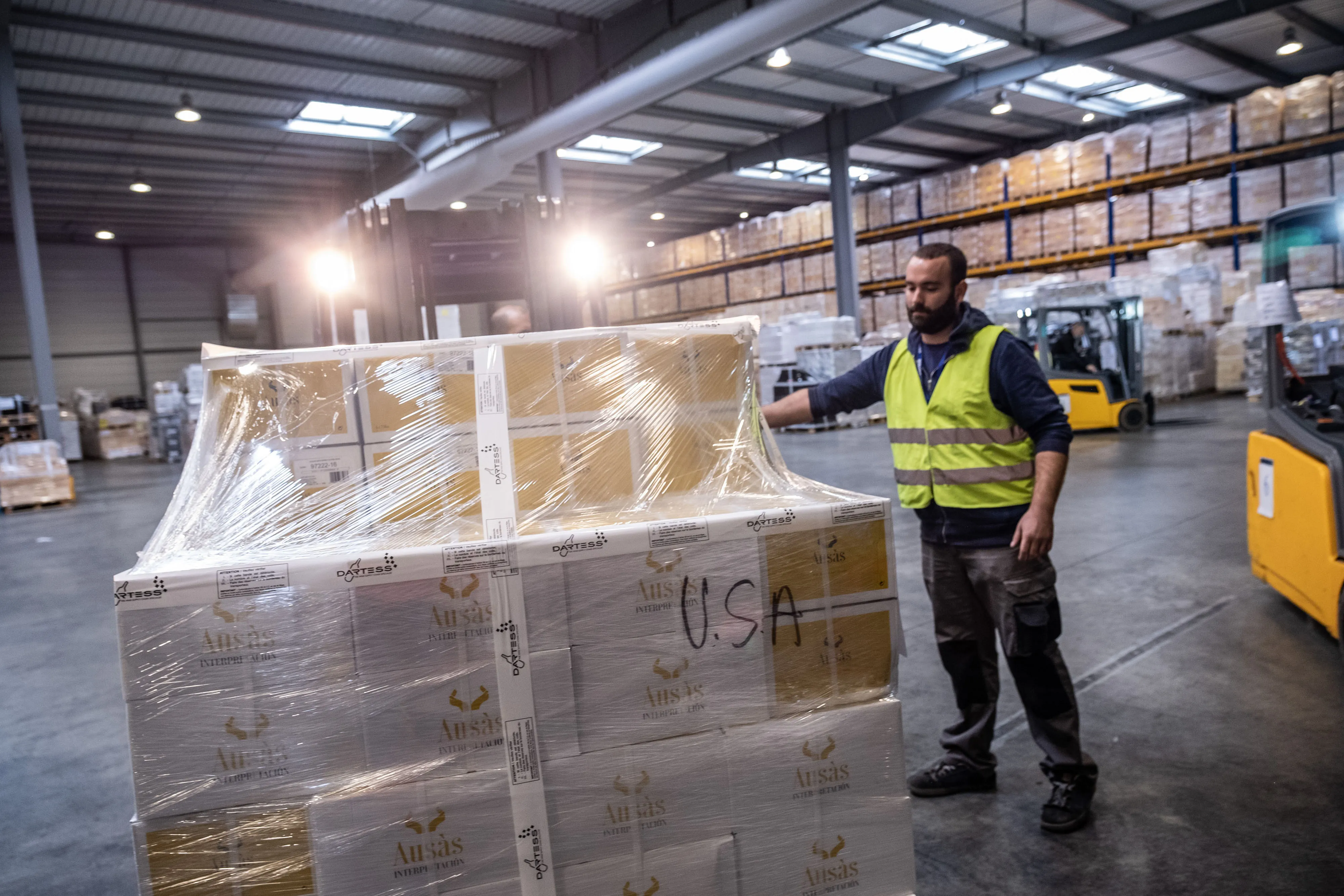 A worker with a pallet of U.S. bound wine inside a&nbsp;logistics warehouse in Blanquefort, France.