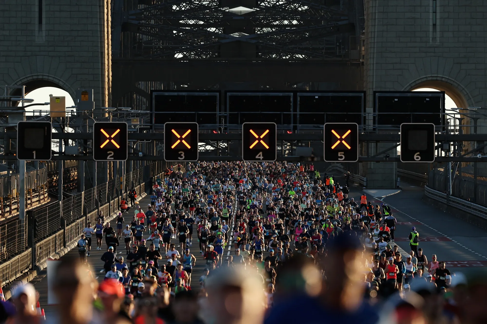Competitors run across the Sydney Harbour Bridge during the 2025 Sydney Marathon on Aug. 31.