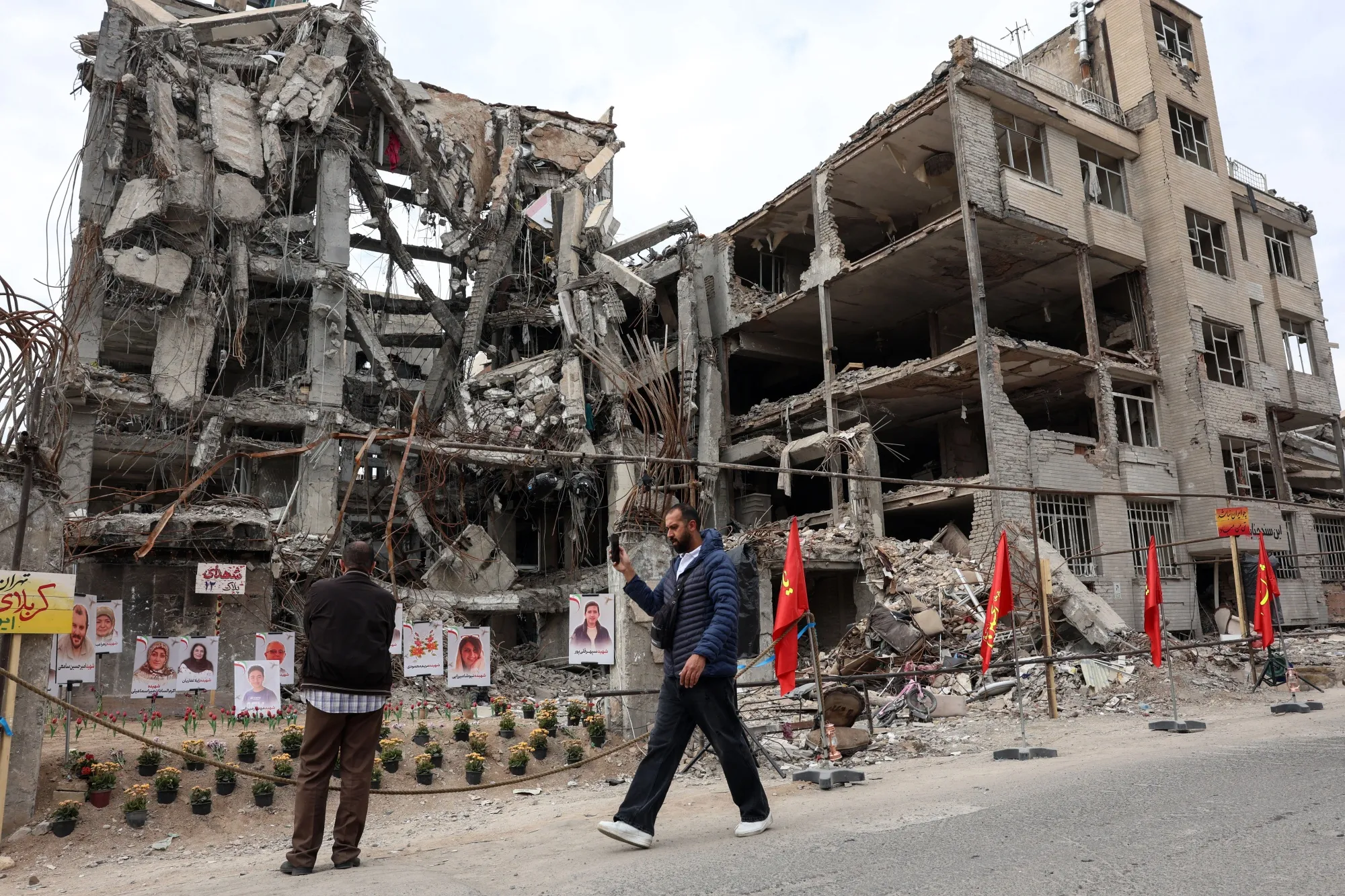 Iranians after an airstrike on a residential building in Tehran on April 13.