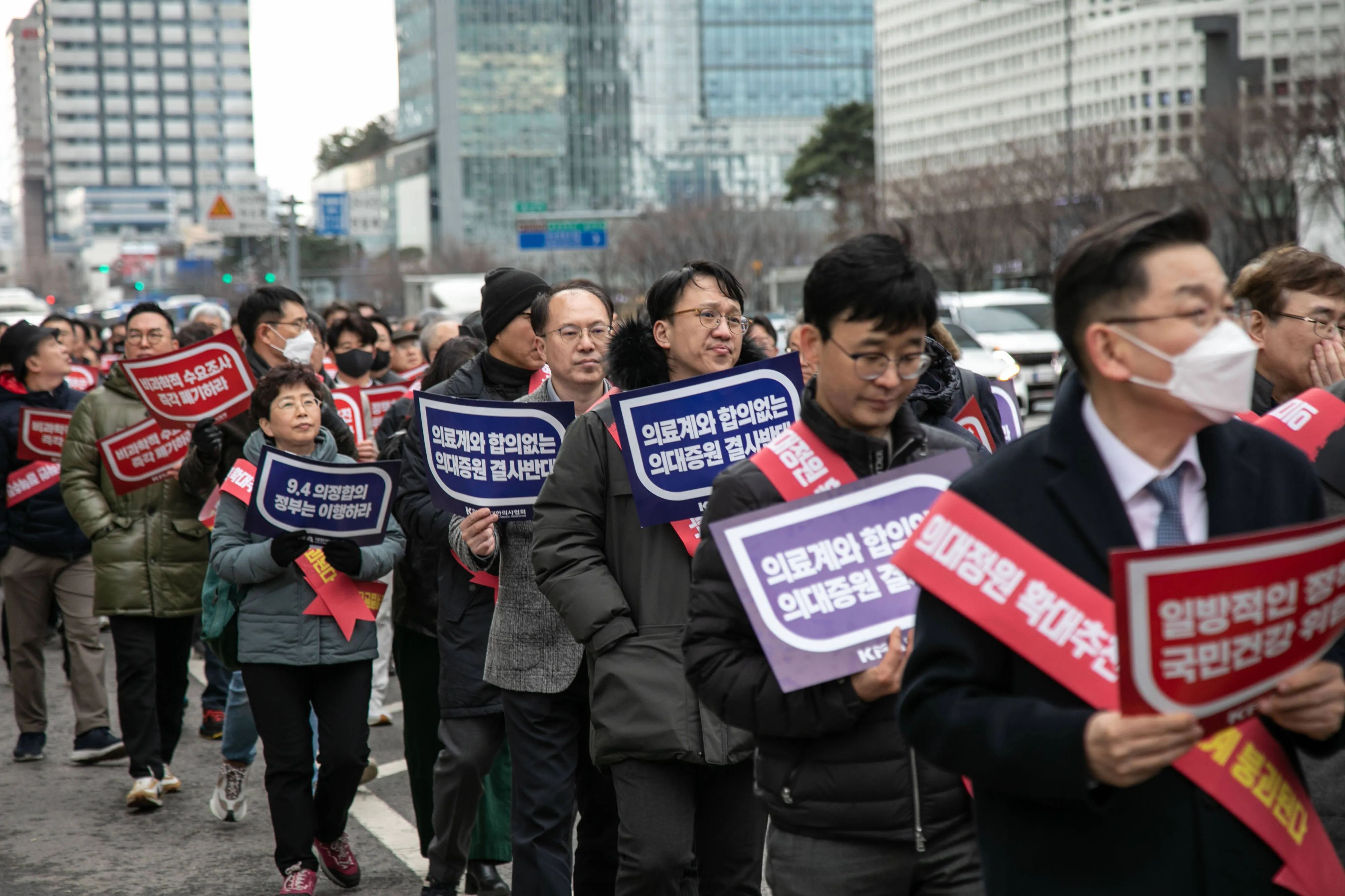 Demonstrators march during a protest in Seoul on Feb. 25.