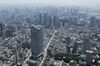 The Toranomon Hills, developed by Mori Building Co., front left, stands while the MacArthur Road, part of the Loop Line No. 2 road connecting the Shimbashi and Toranomon districts, center, is seen in this aerial photograph taken in Tokyo, Japan, on Wednesday, June 24, 2015.