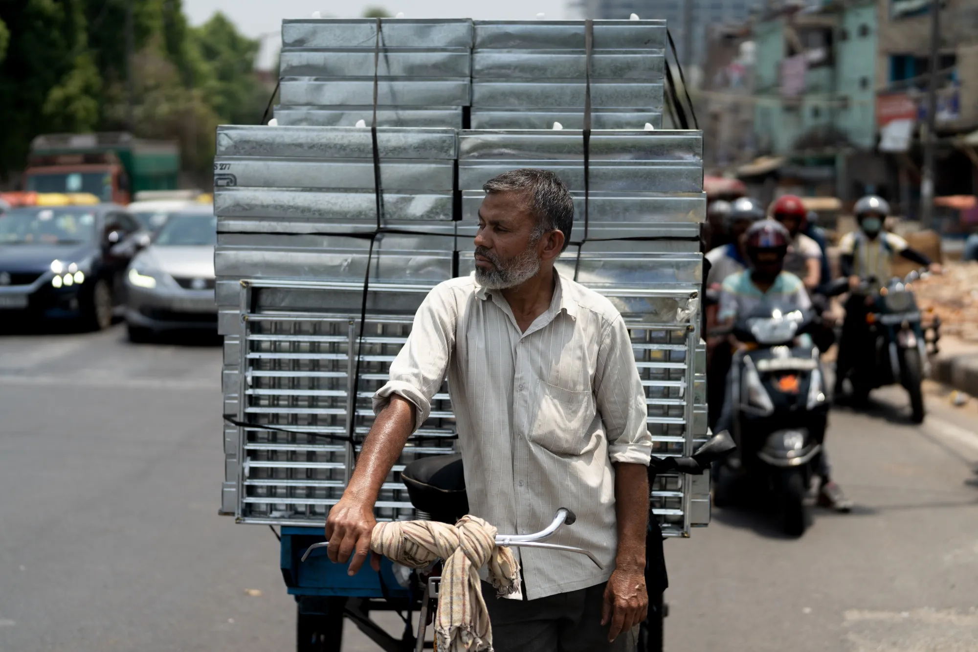 A rickshaw driver delivers air coolers during high temperatures in New Delhi.