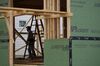 A contractor stands next to a ladder while working on a home under construction in the Norton Commons subdivision in Louisville, Kentucky, U.S., on Monday, March 23, 2020. Purchases of new U.S. homes in February held close to an almost 13-year high, showing momentum in the residential real estate market before economic activity fell victim to the coronavirus.