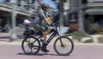 No pain at the pump: a man riding an electric bike in Huntington Beach, California, in April 2021.&nbsp;