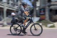 No pain at the pump: a man riding an electric bike in Huntington Beach, California, in April 2021. 
