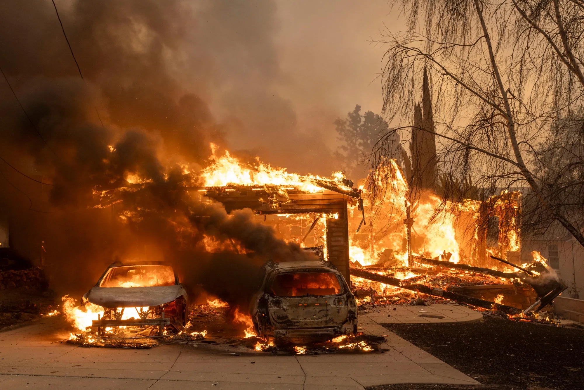 Vehicles burn during the Eaton Fire in Altadena, California in January 2025.&nbsp;