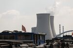 A barge with Chinese flags travels past the Wangting Power Plant in Wangting, Jiangsu province, China .