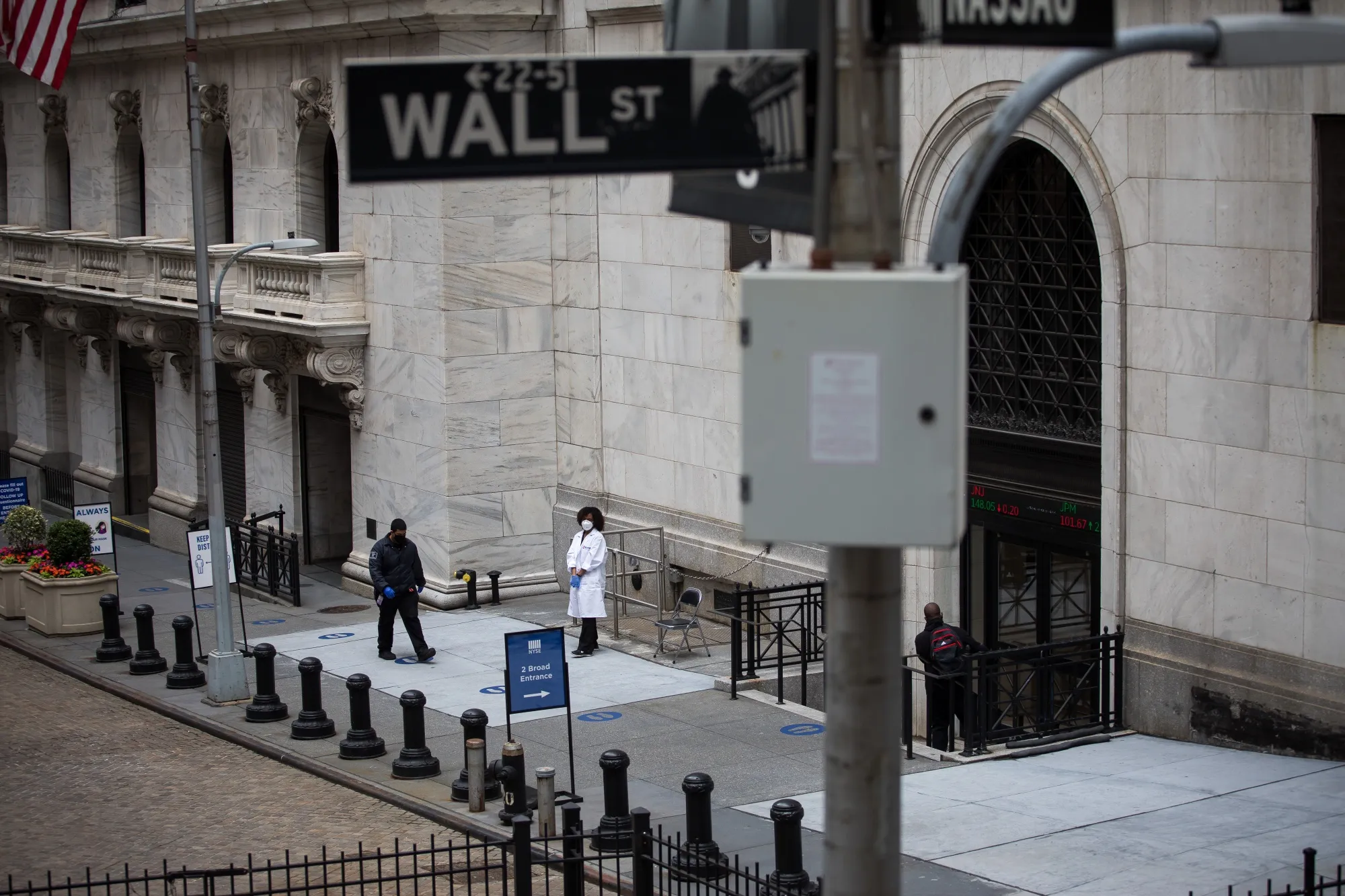 A healthcare worker stands in front of an entrance to the New York Stock Exchange in New York on June 3.